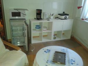 a small kitchen with a table and a coffee table at Villa Cemaste in Montpellier