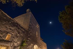 an old building at night with the moon in the sky at Masseria Le Cerase in Conversano +54 photos