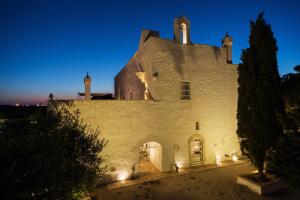an external view of a building at night at Masseria Le Cerase in Conversano