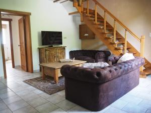 a living room with a couch and a table at La Balade du Ricochet in Tenneville