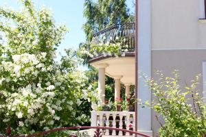a balcony with flowers on the side of a building at Willa Tradycja in Łeba +69 photos