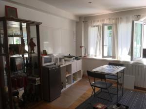 a kitchen with a table and a chair in a room at Villa Cemaste in Montpellier