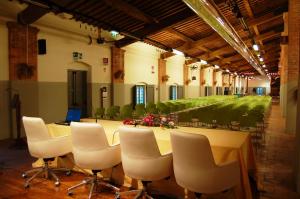 a conference room with a table and chairs and a laptop at Terre Regionali Toscane in Alberese