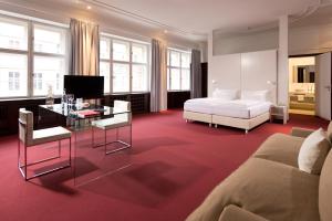 a living room filled with furniture and a large window at Ellington Hotel Berlin in Berlin