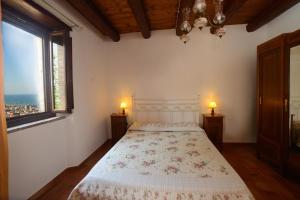 a bedroom with a bed with two lamps on the sides at B&B Borgo Marano in Cupra Marittima