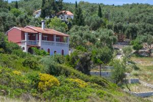 a house on the side of a hill at Paxos Sunrise Villas in Gaios