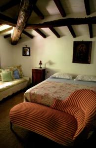 a bedroom with a bed and a couch in it at Bed & Breakfast Villa Masini-Luccetti in Pietrasanta