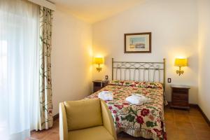 Postel nebo postele na pokoji v ubytování Fattoria La Principina Hotel & Congress