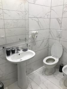 a white bathroom with a sink and a toilet at Donna Margharet in Crotone +59 photos