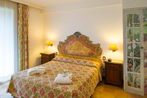 Postel nebo postele na pokoji v ubytování Fattoria La Principina Hotel & Congress