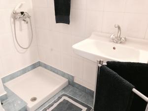 a white bathroom with a sink and a shower at Calypso Beach Hotel in Loutra Edipsou