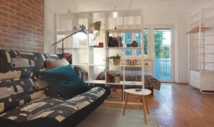 a living room with a couch and a brick wall at Apartments Peter in Ljubljana