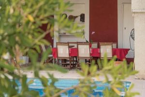 a dining room with red tables and chairs at Villa Cemaste in Montpellier