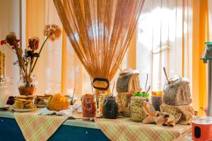 a table topped with jars of food on top at Irene Palace Beach Resort in Kolimbia