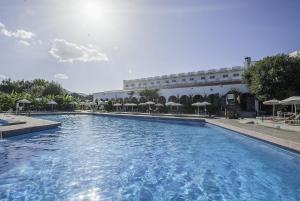 a large swimming pool in front of a building at Irene Palace Beach Resort in Kolymbia