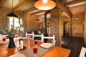 a dining room with a table with wine glasses at MAZURY chillout in Ryn