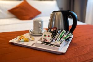 a tea pot sitting on top of a table at Adria Hotel in London