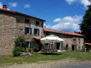 a building with an umbrella in front of it at La Rosière in Auzelles