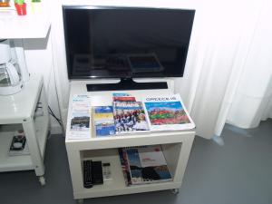 a tv on a stand with a computer on it at Newly Renovated Apt in Kolonaki in Athens