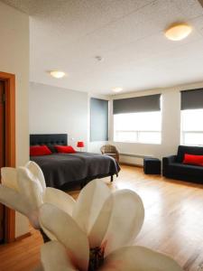 a room with a bed and a flower on the floor at Volcano Hotel in Vík