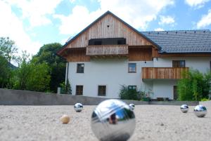 a group of balls on the ground in front of a house at Country House Trata in Kranjska Gora
