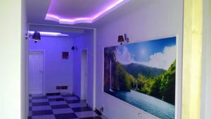 a room with a large flat screen tv on a wall at Hotel Buza in Shkodër