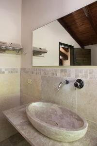 a bathroom with a large sink and a mirror at Tenuta Folesano Wine Estate 13th century in Marzabotto
