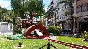 a red sculpture in the middle of a street at Puerto Pinar Luxe in Guardamar del Segura