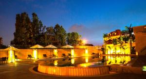 a building with a swimming pool at night at The Rooms Boutique Hotel in Jounieh