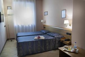 Postel nebo postele na pokoji v ubytování Hotel Bernardino