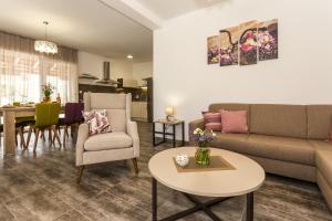 a living room with a couch and a table at Villa Rusula in Kastel Novi