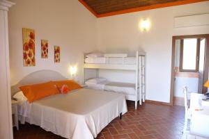 a bedroom with a bed and a bunk bed at Agriturismo Poggio al Sasso in Blera +3 photos