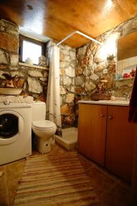 a bathroom with a toilet and a sink at Mike Omalos Houses in Omalos