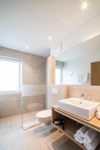 a bathroom with a sink and a toilet and a shower at Residence Hochwart ***S in Naturno