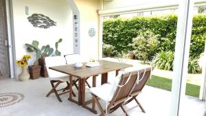 a wooden table and chairs on a patio at Casa Amore by Holiday World in Santa Margherita Ligure