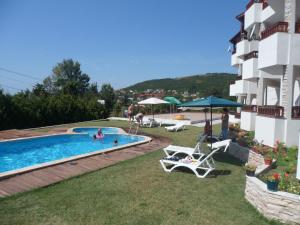 a hotel with a swimming pool with people in it at Morski Briz in Balchik