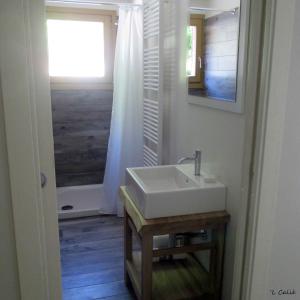 a bathroom with a white sink and a window at 'L Calié in Valdieri
