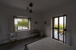 a white bedroom with a bed and a window at Agriturismo Il Giriatello in Crotone +65 photos