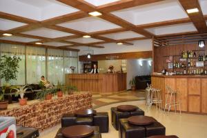 a lobby with a bar and stools in a restaurant at Hotel Sanda in Venus