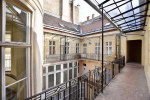 an empty balcony of an old building with a window at Luxury Apartment by Hi5 - Szervita Suite in Budapest