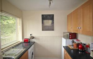 a kitchen with a sink and a counter top at Boswell - Large Balcony Apartment & Parking - 2 Bedrooms - Close to Town & Racecourse in Doncaster