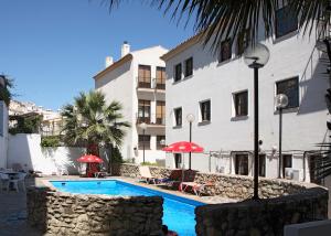 a swimming pool in front of a building at Apartamentos San Pedro in Cazorla