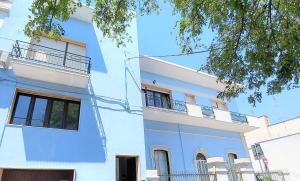 - un bâtiment blanc avec des balcons sur le côté dans l'établissement b&b MareSalento, à Racale