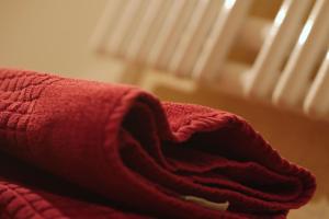 un asciugamano rosso seduto sopra un letto di Gasthof Vossbur a Toppenstedt