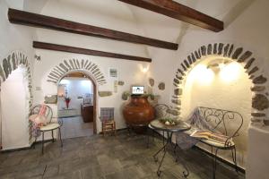a living room with an archway and a table and chairs at Schinos Apartments in Mestá