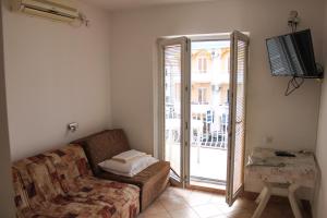 TV in/ali zabaviščno središče v nastanitvi Apartmani Vukcevic