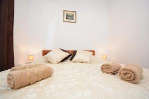 a bedroom with a large bed with towels on it at Apartment Zita in Zadar