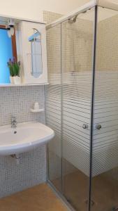 a bathroom with a glass shower and a sink at Demetra Malophoros in Marinella di Selinunte