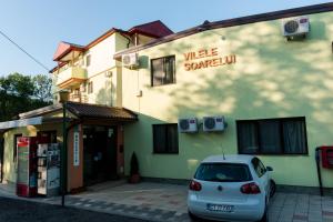 a car parked in front of a building at Vilele Soarelui in Neptun