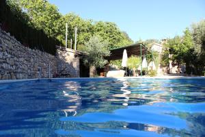 a swimming pool in a house with a stone wall at La Toba in Burunchel
